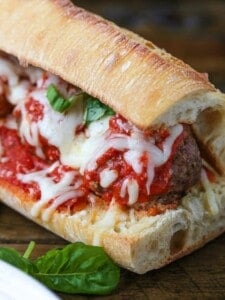 meatball sub on a board with fresh basil