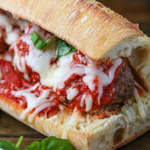 meatball sub on a board with fresh basil