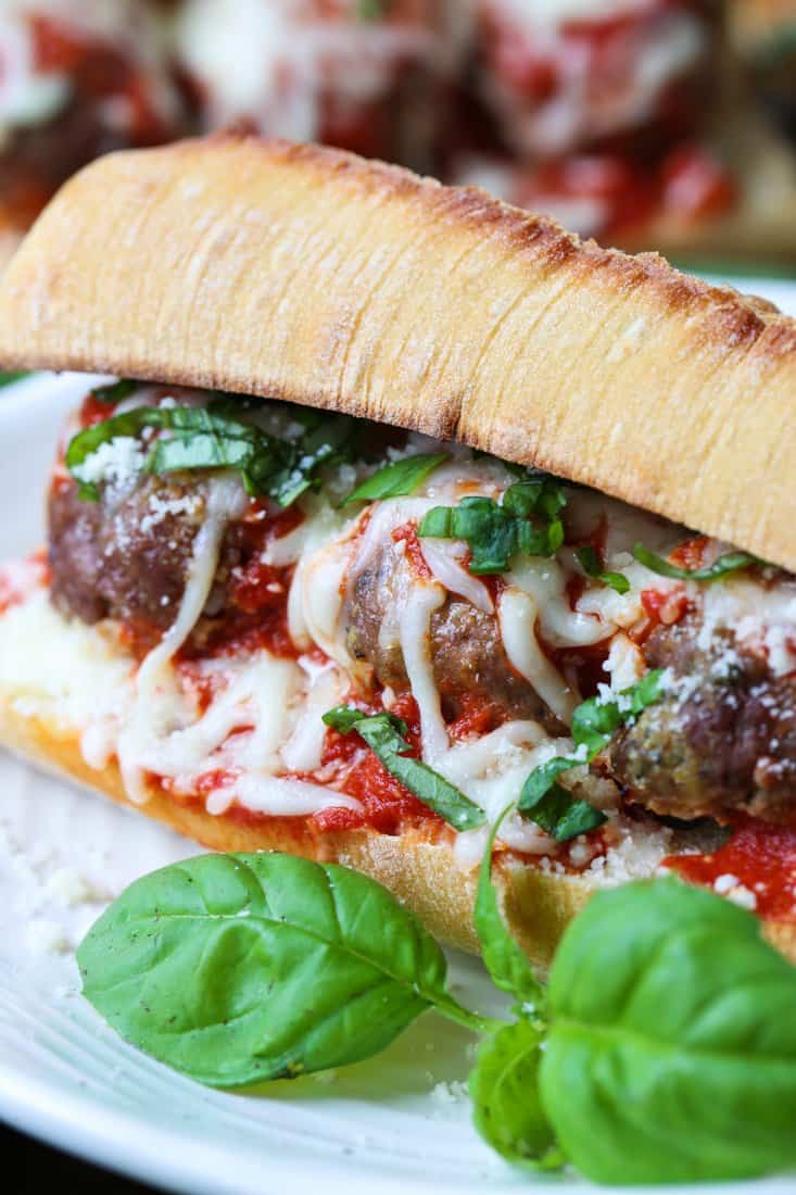 meatball sub recipe on a plate with basil