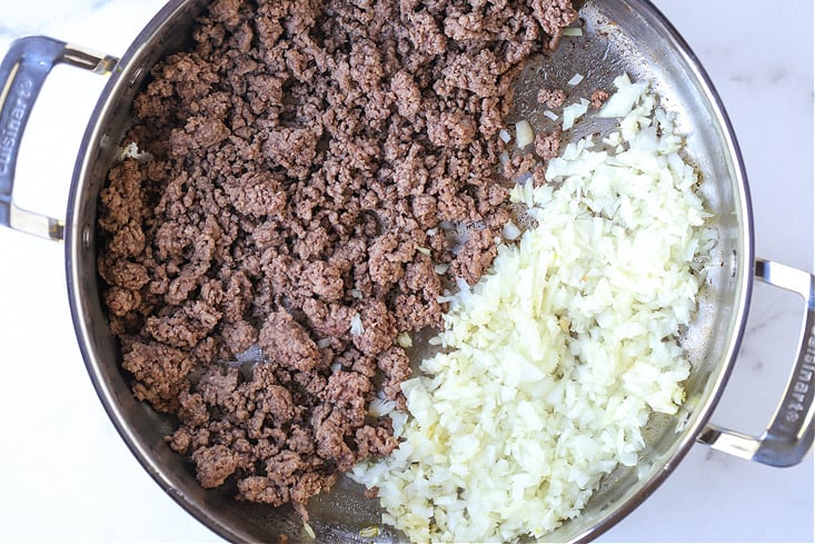 ground beef and onions in a pot for spaghetti recipe