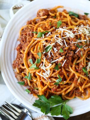 Spaghetti and beef recipe on a plate with fresh parsley