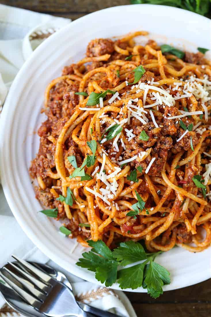 Spaghetti and beef recipe on a plate with fresh parsley