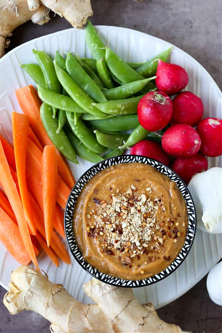 This is our go-to Peanut Sauce Recipe for using in many different recipes! A creamy, savory dip for veggies, a sauce for pasta or salads, or a drizzle over chicken or steak! a platter of vegetables with peanut sauce