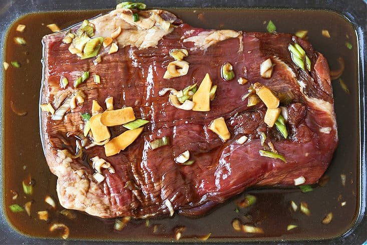 flank steak marinating in a teriyaki marinade