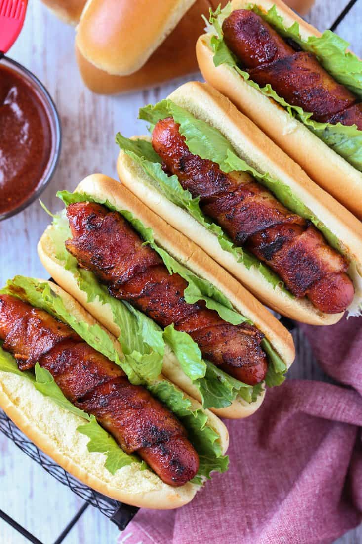 bacon wrapped hot dogs on a serving tray