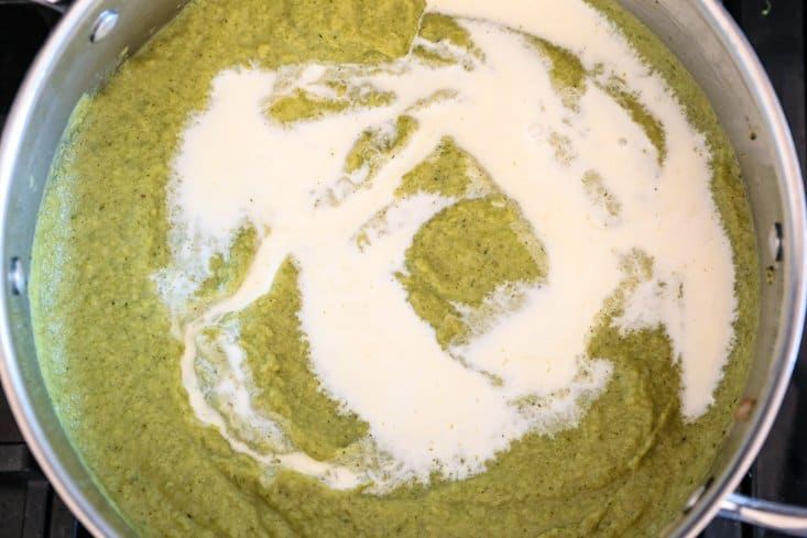 cream swirled into broccoli soup