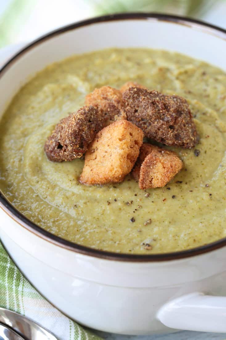 cream of broccoli soup in a crock with croutons