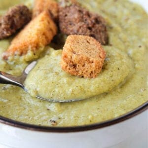 cream of broccoli soup with a spoon and croutons