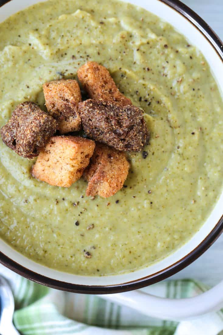 Cozy up to a bowl of this delicious Cream of Broccoli Soup! A nutritious soup recipe that gives you a luxurious, indulgent feel! cream of broccoli soup with croutons in a bowl