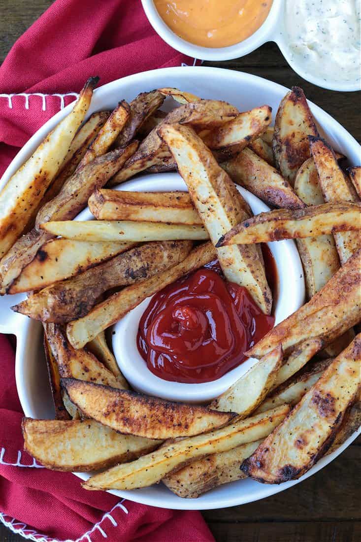 steak fries in a white serving platter with ketchup