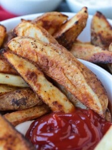 steak fries in a serving bowl with ketchup