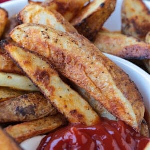 steak fries in a serving bowl with ketchup