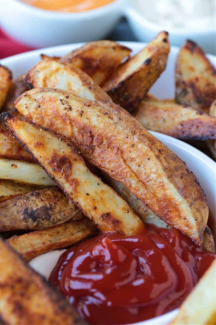 steak fries in a serving bowl with ketchup