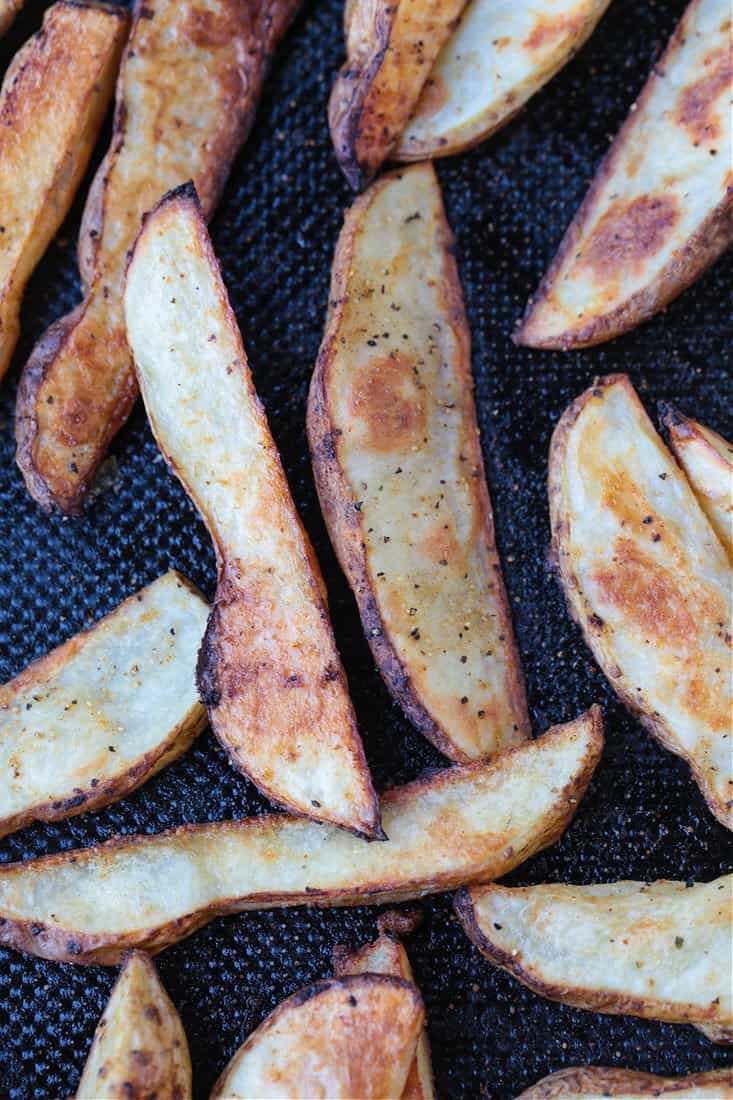 steak fries on a black baking sheet