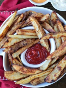 steak fries in a white serving platter with ketchup