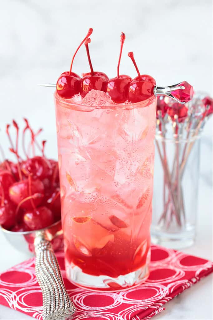 dirty shirley drink with cherries and napkin
