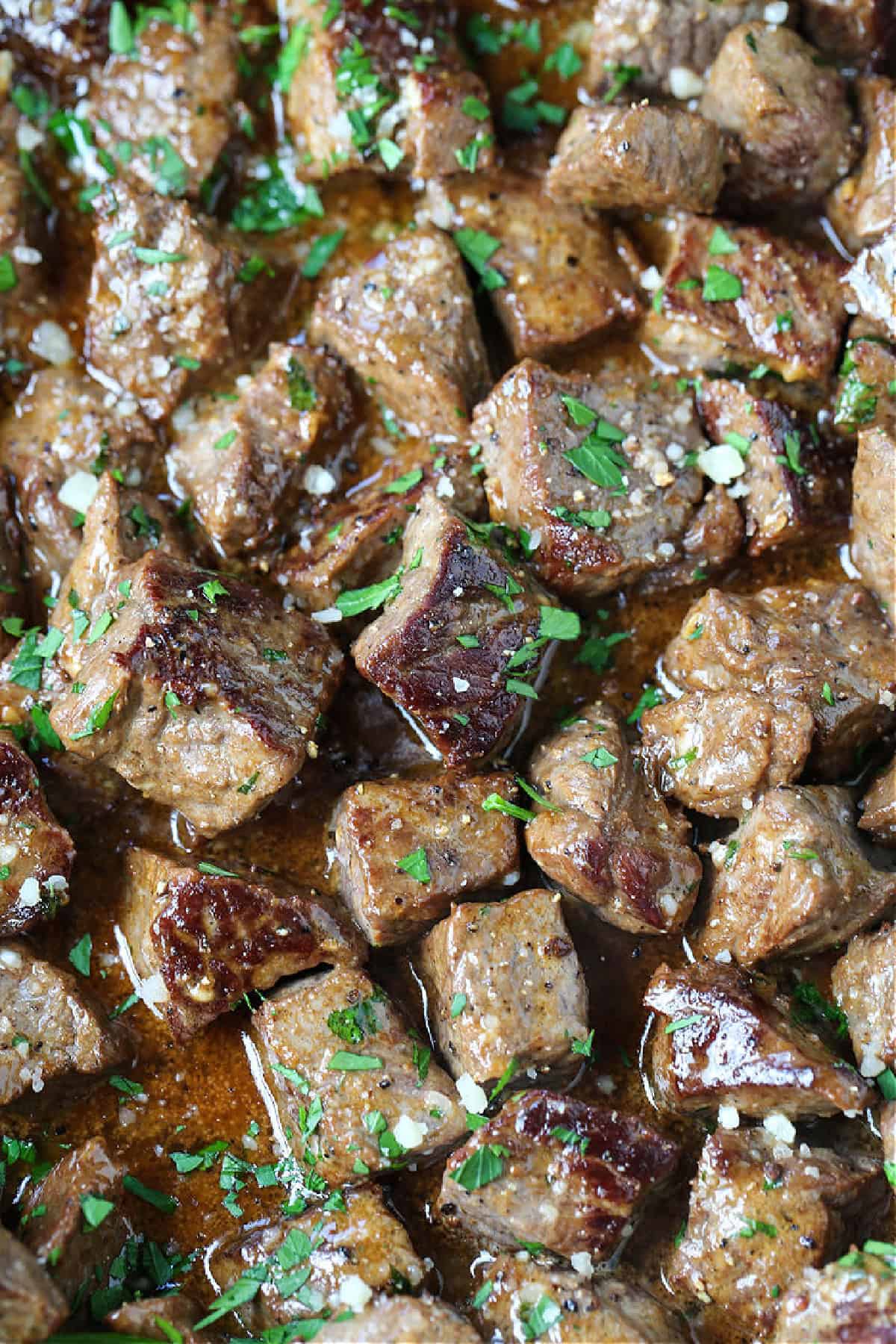 Sink your teeth into our Garlic Butter Steak Bites! Tender steak tossed in our famous garlic parmesan sauce, ready to eat in just 15 minutes! garlic butter steak bites with parsley