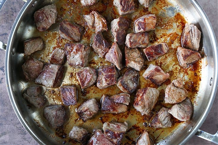 seared steak bites in a skillet with butter