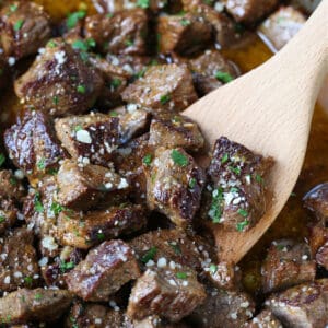 garlic parmesan steak bites in a skillet with spatula