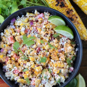 mexican street corn salad in a bowl with grilled corn on the side