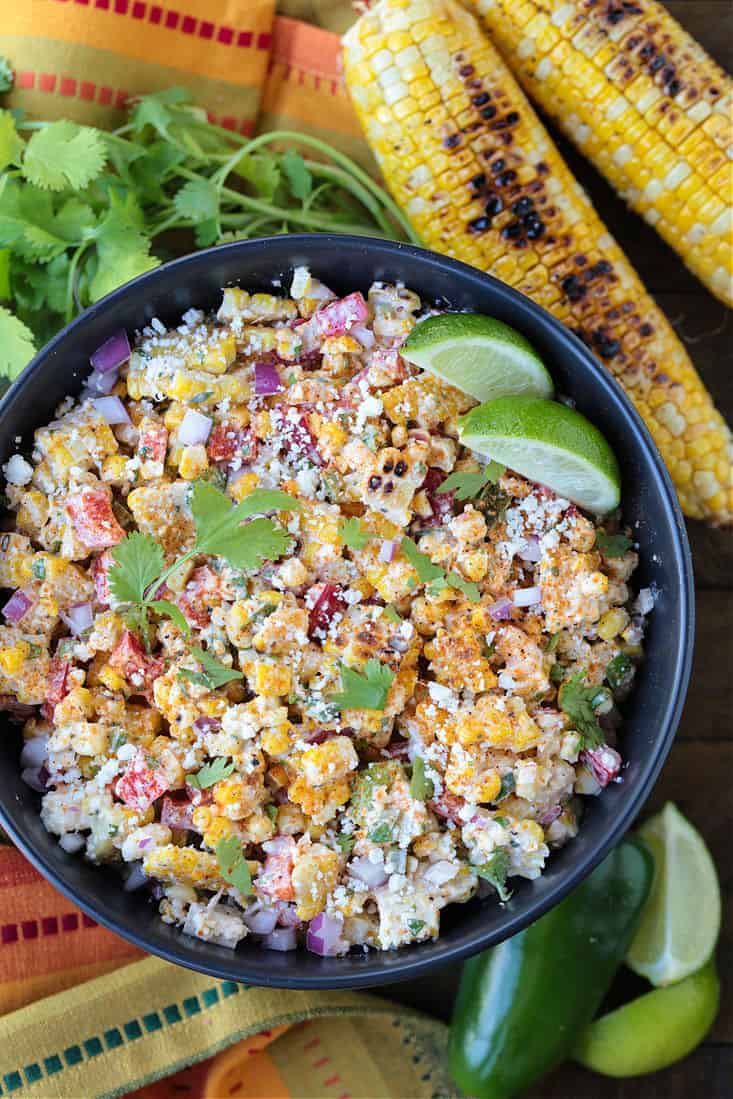 mexican street corn salad in a bowl with grilled corn on the side