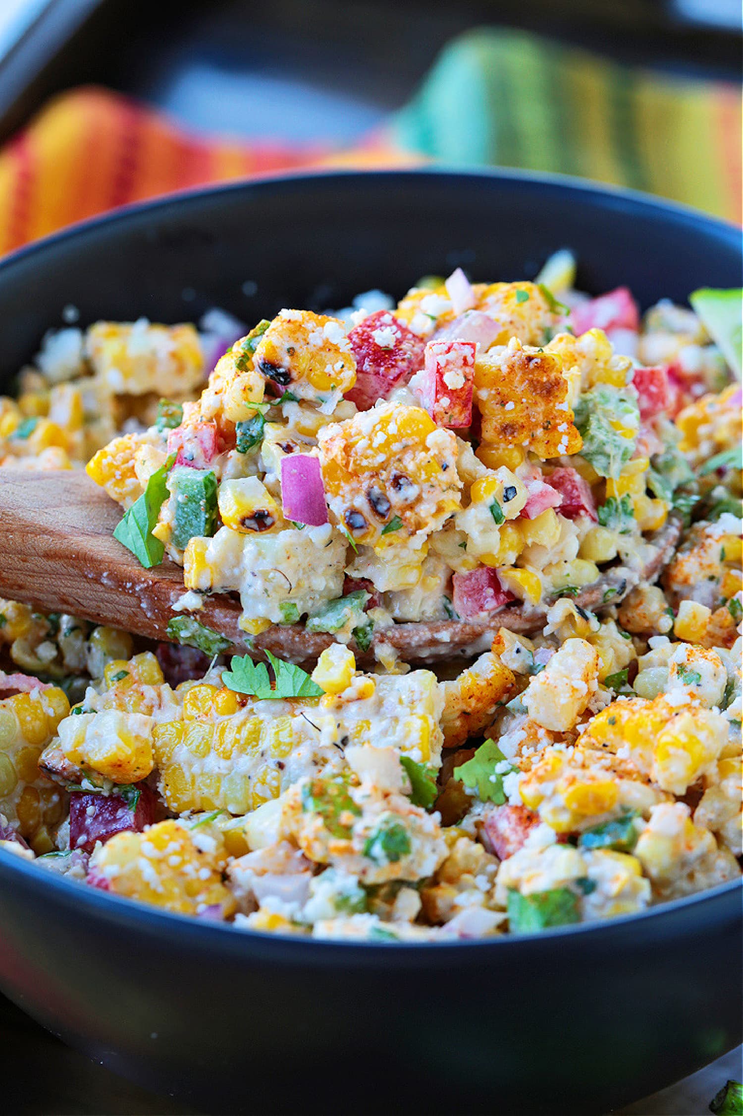 corn salad on a wooden spoon in a bowl