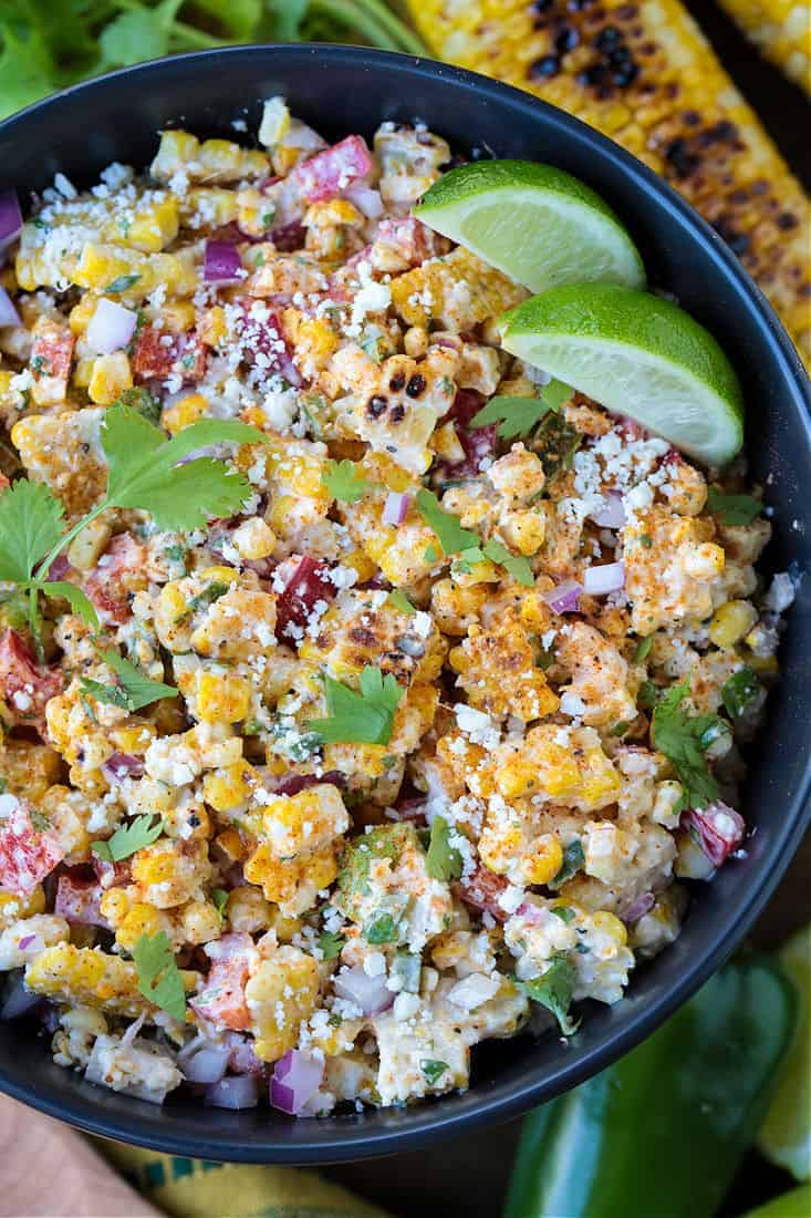 corn salad with mayo dressing in a black bowl