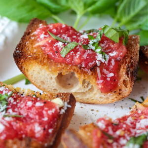 Spanish tomato bread on platter with basil