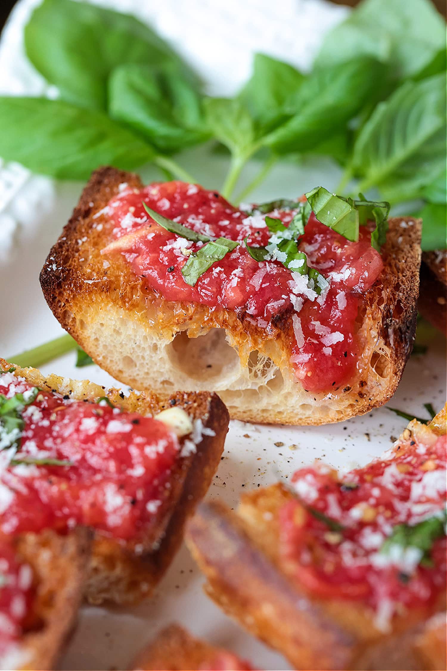 Spanish tomato bread on platter with basil