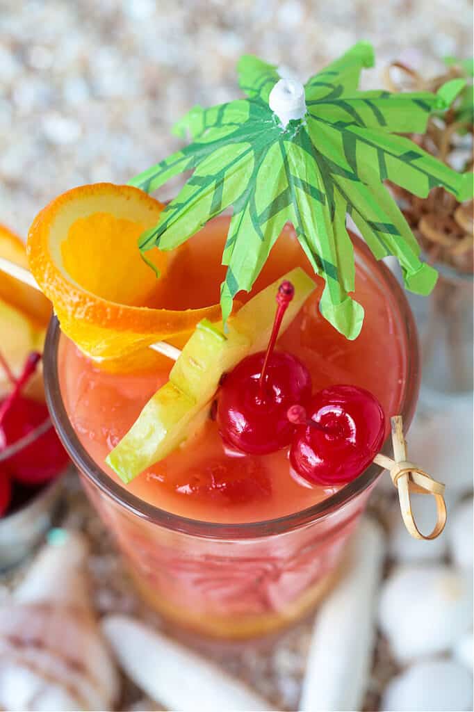 fruit garnish on a cocktail with umbrella