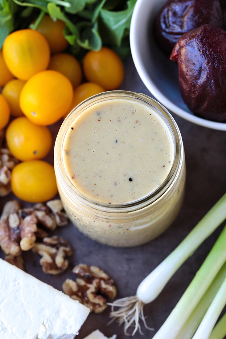 creamy maple dressing in the middle of salad ingredients