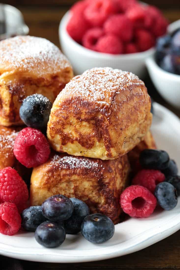 french toast made with Hawaiian rolls stacked on a plate