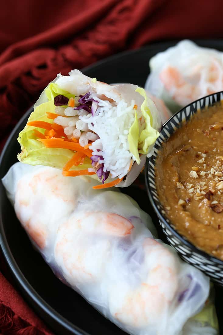 Shrimp Spring Rolls are so light and fresh – making them at home is easier than you think! Serve with our addicting peanut sauce for dipping! picture showing the filling of a shrimp spring roll