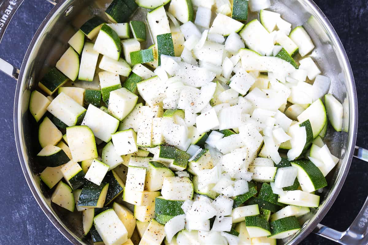 Zucchini Pasta Sauce can be used with any pasta shape, even in lasagna! Fresh and creamy and packed with tons of fresh zucchini flavor! diced zucchini and onions in a skillet
