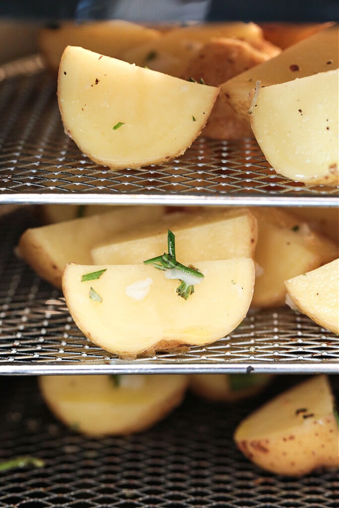 These Air Fryer Baby Potatoes are so crispy on the outside and tender and fluffy on the inside! A 15 minute, healthy side dish! potatoes in an air fryer with fresh rosemary
