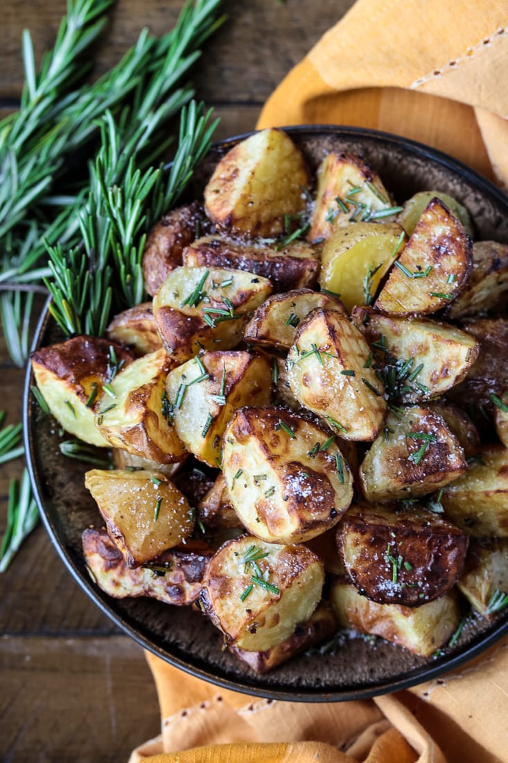 These Air Fryer Baby Potatoes are so crispy on the outside and tender and fluffy on the inside! A 15 minute, healthy side dish! air fried potatoes in a bowl with rosemary