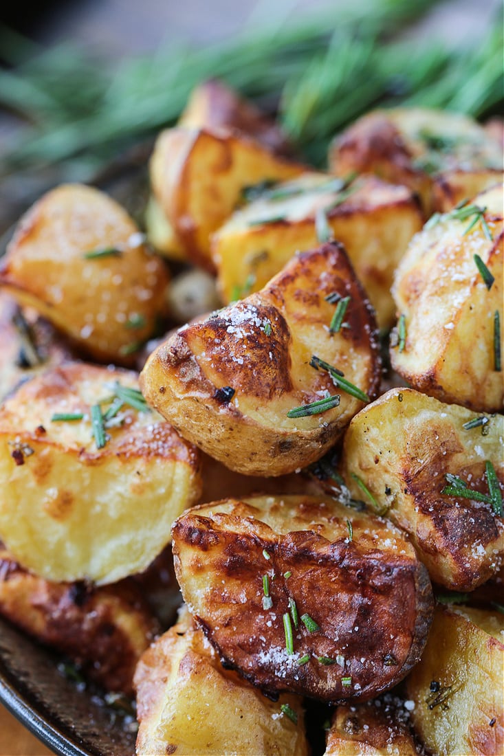 These Air Fryer Baby Potatoes are so crispy on the outside and tender and fluffy on the inside! A 15 minute, healthy side dish! air fried potatoes in a bowl with rosemary