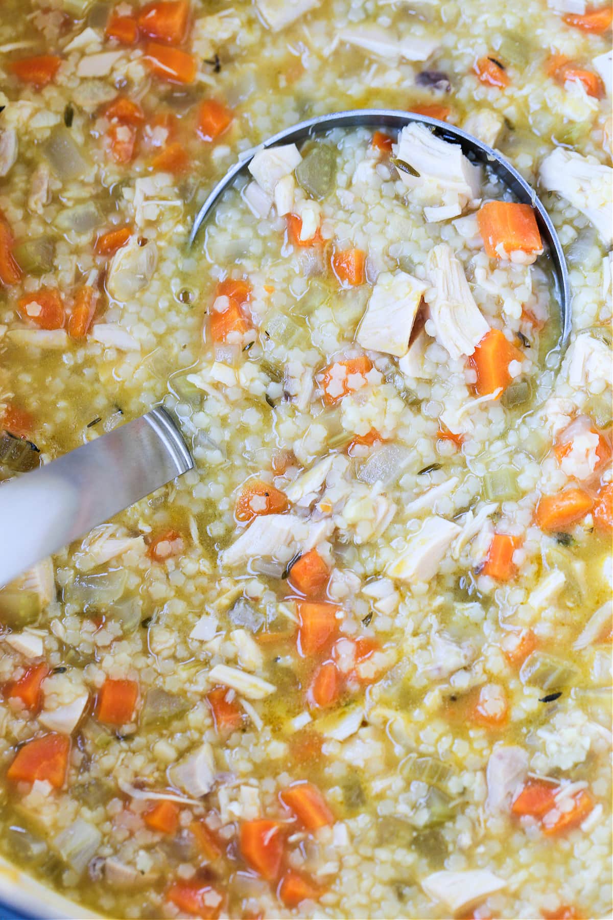 ladle in a pot with chicken pastina soup