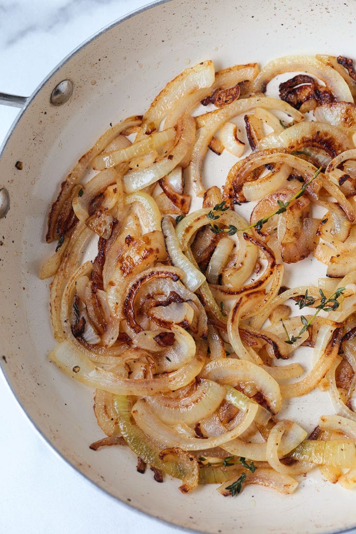 Caramelized onions in a skillet with thyem