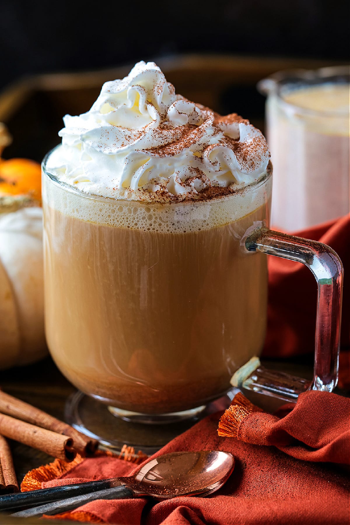 Pumpkin Spice Creamer is so easy to make at home! Enjoy this cozy, homemade pumpkin coffee creamer in your lattes, hot or iced coffee! coffee in a glass mug with whipped cream and pumpkin spice creamer