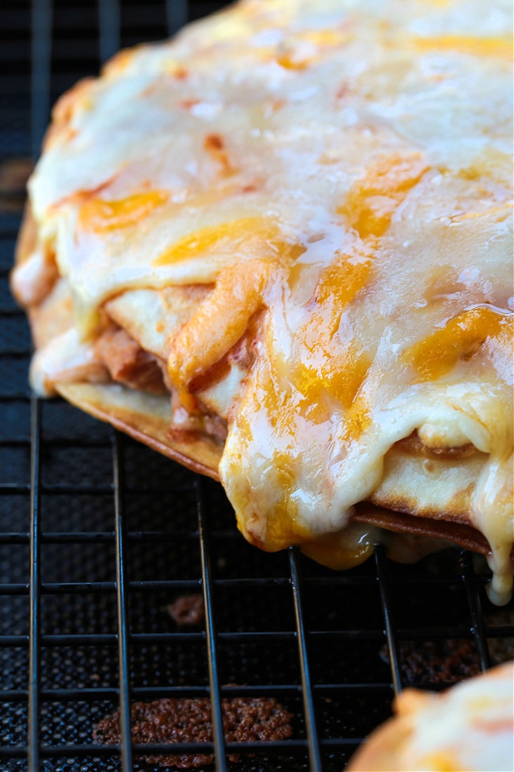 melted cheese on top of a mexican pizza