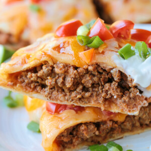 slice of mexican pizza stacked on plate with toppings