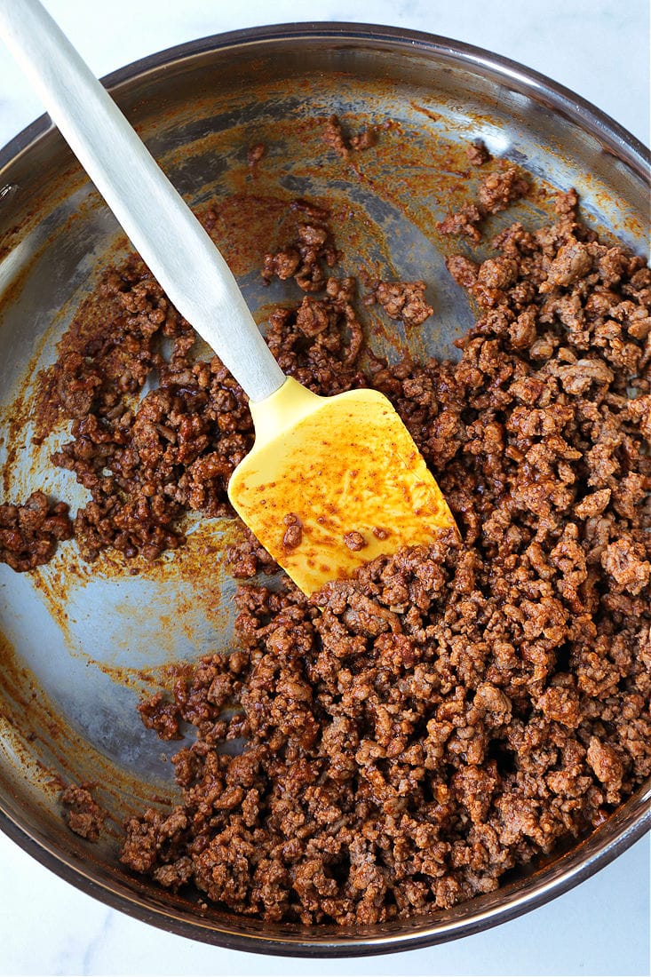 taco meat in a skillet for making mexican pizza