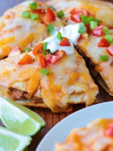 mexican pizza cut into wedges with toppings
