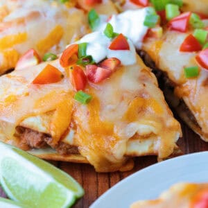 mexican pizza cut into wedges with toppings