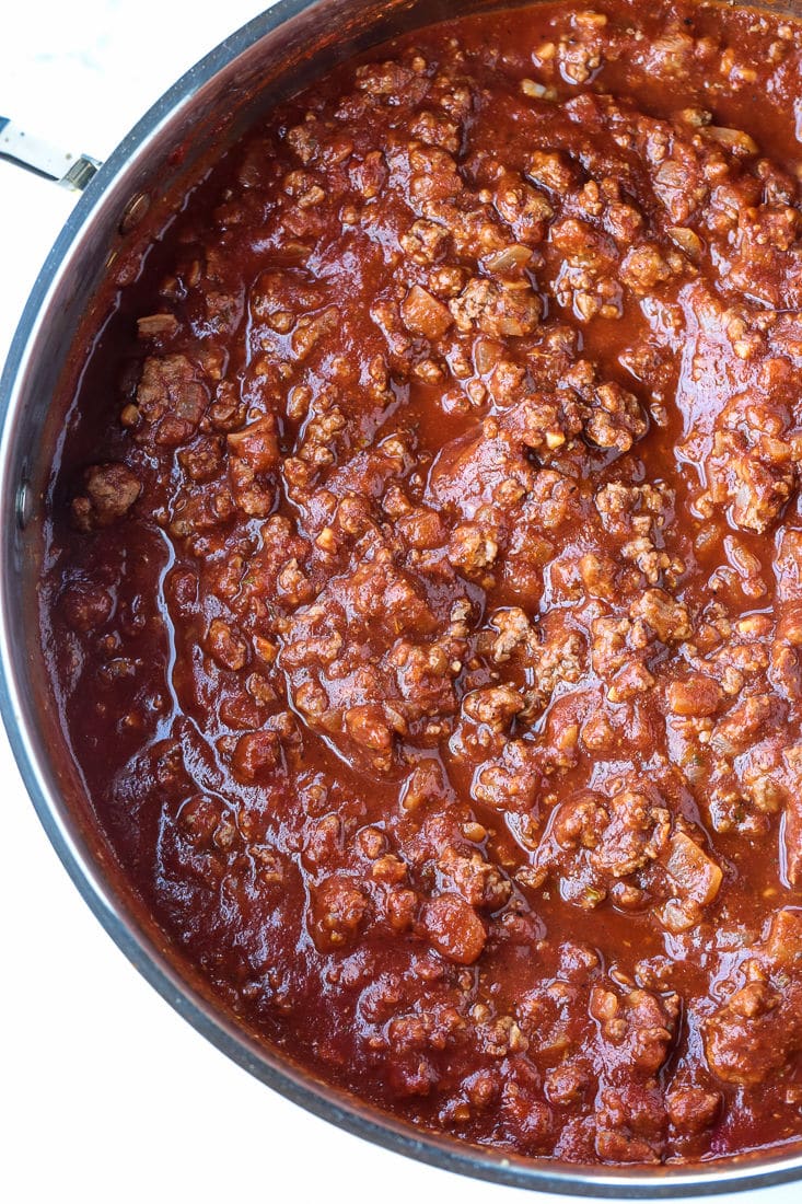 Tomato and beef sauce simmering in a pan