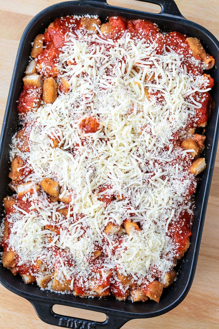 casserole with chicken nuggets and ziti in a black baking dish