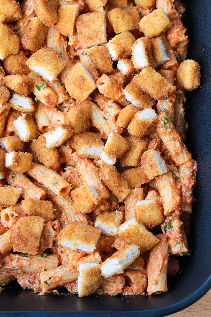 chicken parmesan casserole in black baking dish