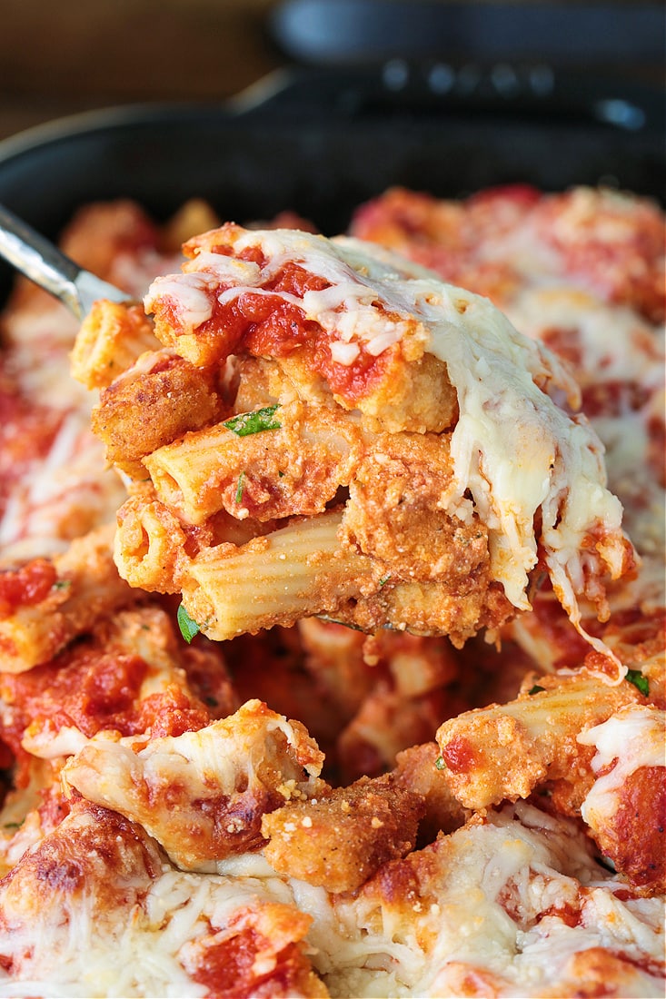 chicken parmesan casserole on a serving spoon