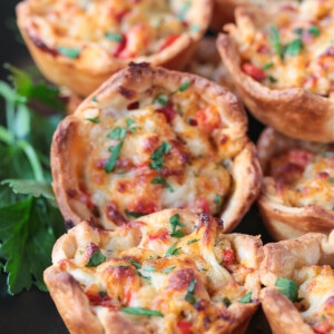 crab puffs on black platter with parsley